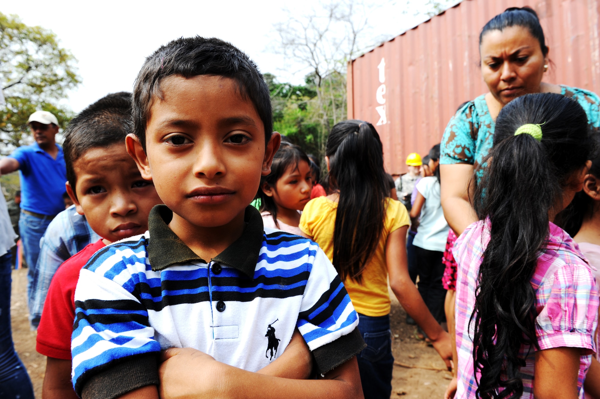 Guatemalan children await the start of the groundbreaking ceremony for a school construction project being built by 188th Civil Engineer Squadron, Arkansas Air National Guard, assigned to Task Force Oso for Exercise Beyond the Horizon near El Robles, Guatemala, April 8, 2014. Beyond the Horizon is a humanitarian and civic assistance mission deploying U.S. military engineers and medical professionals to Guatemala for training and to provide humanitarian services. (U.S. Army photo by Staff Sgt. Michael L. Casteel) 