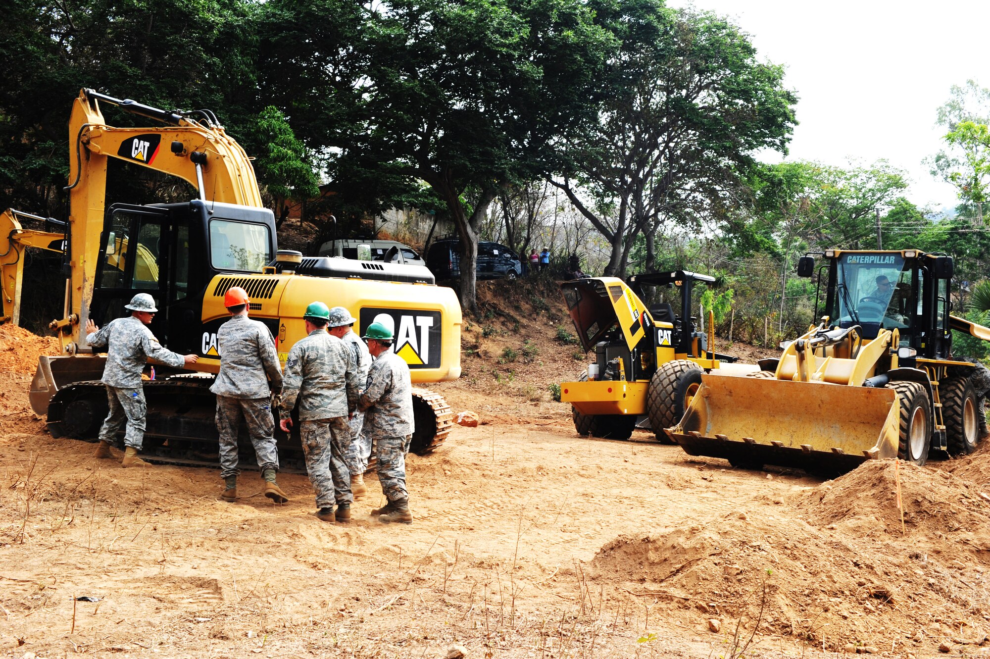 188th Civil Engineer Squadron assigned to Task Force Oso inspect their heavy equipment during a school construction project for Exercise Beyond the Horizon near El Robles, Guatemala, April 8, 2014. Beyond the Horizon is a humanitarian and civic assistance mission deploying U.S. military engineers and medical professionals to Guatemala for training and to provide humanitarian services. (U.S. Army Photo by Staff Sgt. Michael L. Casteel) 