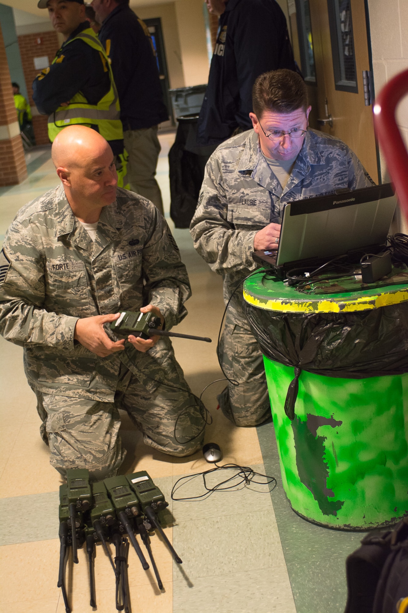 Master Sgt. Michael Forte and Staff Sgt. Arthur Laurie, radio frequency transmission technicians, 267th Combat Communications Squadron, perform frequency checks on hand-held radios in support of National Guard communications for the Boston Marathon here, April 21. The Massachusetts National Guard continues to support local authorities at the Boston Marathon every year. (Air National Guard photo by Tech. Sgt. Kerri Spero/Released)