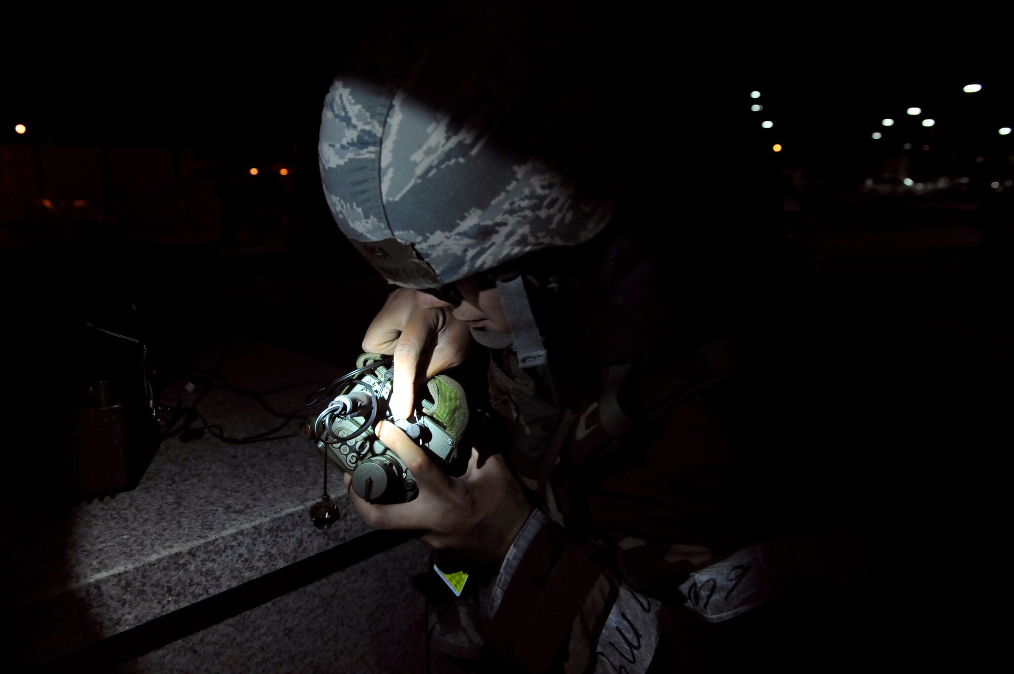 Senior Airman Sean McKeel, 51st Civil Engineer Squadron readiness journeyman, connects a field wire to a joint chemical agent detector for an alarm that is linked to a M42 alarm inside of the control center May 5 on Osan Air Base, Republic of Korea. The alarm can detect multiple chemical hazards. (U.S. Air Force photo by Senior Airman David Owsianka)