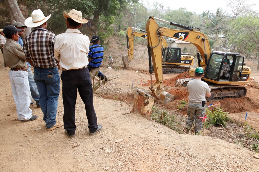 Airmen with the 188th Civil Engineer Squadron level the ground to build a school in El Robles, Guatemala, April 8, 2014, in support of Beyond the Horizon, which is a U.S. partnership with the government of Guatemala conducting various medical, dental and civic actions programs, providing focused humanitarian assistance. (U.S. Army photo by Sgt. 1st Class Marcus J. Quarterman)