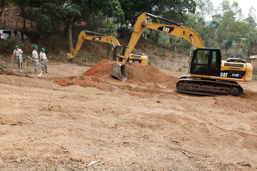 Airmen with the 188th Civil Engineer Squadron level the ground to build a school in El Robles, Guatemala, April 8, 2014, in support of Beyond the Horizon, which is a U.S. partnership with the government of Guatemala conducting various medical, dental and civic actions programs, providing focused humanitarian assistance. (U.S. Army photo by Sgt. 1st Class Marcus J. Quarterman)