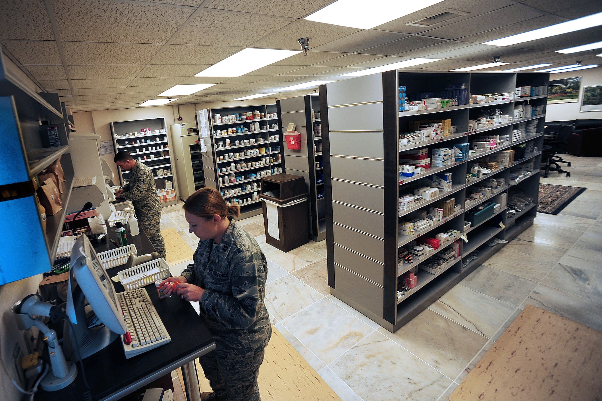 Staff Sgt.  Adam Keegan, 39th Medical Group pharmacy technician, and Capt. Christine Cox, 39th MDG chief pharmacist, attend to patients receiving medications from the 39th MDG pharmacy May 5, 2014, Incirlik Air Base, Turkey.  Base pharmacies have a disposal drop box for year round deposit of unwanted medications. (U.S. Air Force photo by Senior Airman Nicole Sikorski/Released) 