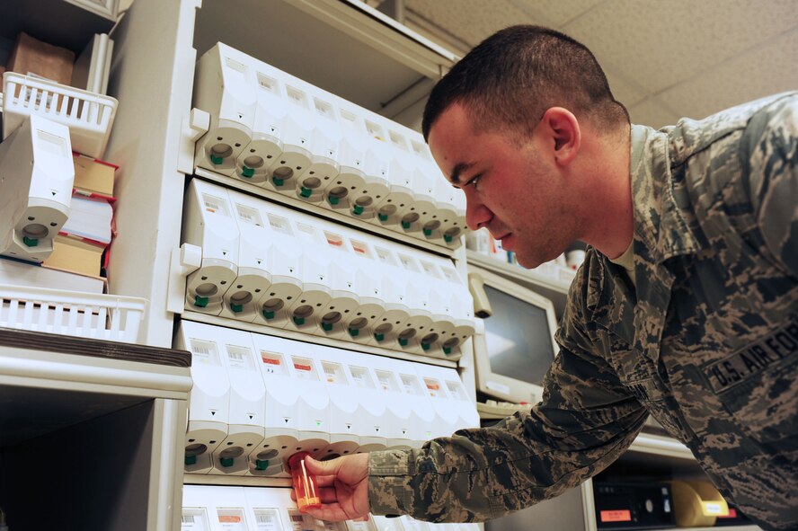 Staff Sgt.  Adam Keegan, 39th Medical Group pharmacy technician, refills a prescription May 5, 2014, Incirlik Air Base, Turkey.  Airmen who take prescription pills that are not their own or are taken after the time allotted could find themselves facing severe disciplinary actions. (U.S. Air Force photo by Senior Airman Nicole Sikorski/Released) 