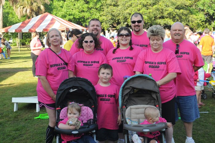 Sheryl Sande (far left) and Glenn Caddell (far right), 841st Transportation Battalion civilians, walked for team “Sophie’s Super Squad” with Sophie (front left) leading the way.