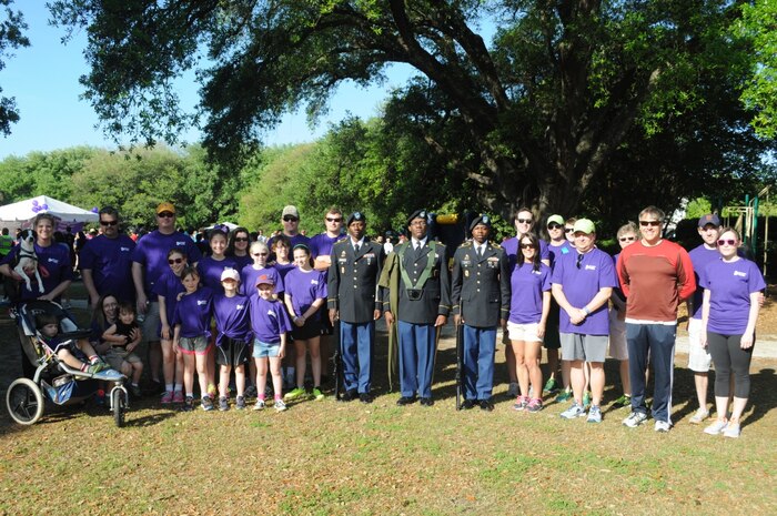 The 841st Transportation Battalion Color Guard, along with Navy Lt. Cmdr. Anthony Seifert, 841st TB deputy commander (red shirt) and Honorary Commander Sean Mummert (Seifert’s right) gather for a Charleston Imaging Products team photo. (Courtesy photo)