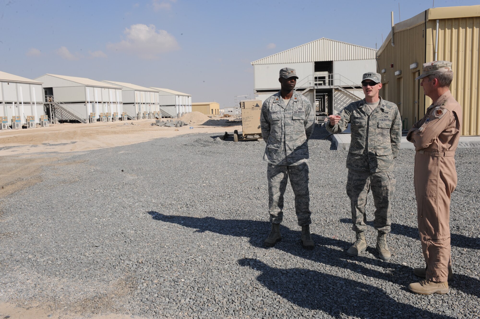 Capt. Charles Comfort (center), 380th Expeditionary Civil Engineer Squadron, provides a briefing to Gen. Gilmary Michael Hostage III, commander Air Combat Command, during a visit to the 380th Air Expeditionary Wing on November 27, 2013. Comfort, who is a native of Morris, Ill., provided the status of the relocatable billets (RLBs), which upon completion, will house members of the 380 AEW. Comfort also provided Gen. Hostage an update on the upgrades to the utility infrastructure supporting the RLBs.
(U.S. Air Force photo by Staff Sgt. Michael Means/Released)  
