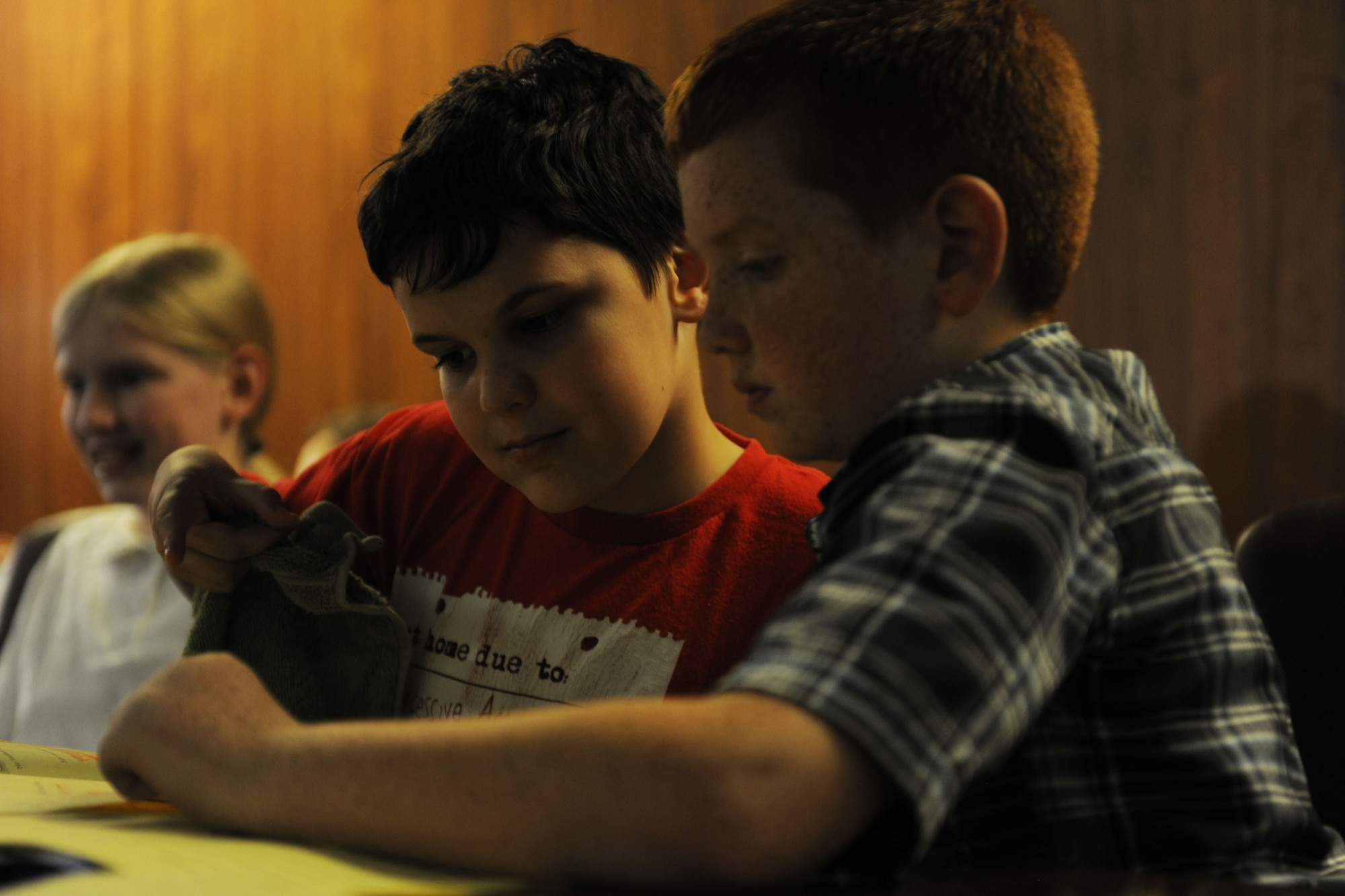 Benjamin Bradley Wolf, left, portrayed by Alconbury Elementary School student Evan Utter, and his defense attorney, played by fellow student Kaden Traylor, review their case before presenting opening arguments during the 2014 Law Day mock trial at RAF Alconbury, United Kingdom, May 1, 2014. Law Day was hosted as a partnership between Alconbury Elementary and the 501st Combat Support Wing Judge Advocate Office. (U.S. Air Force photo by Staff Sgt. Jarad A. Denton/Released)