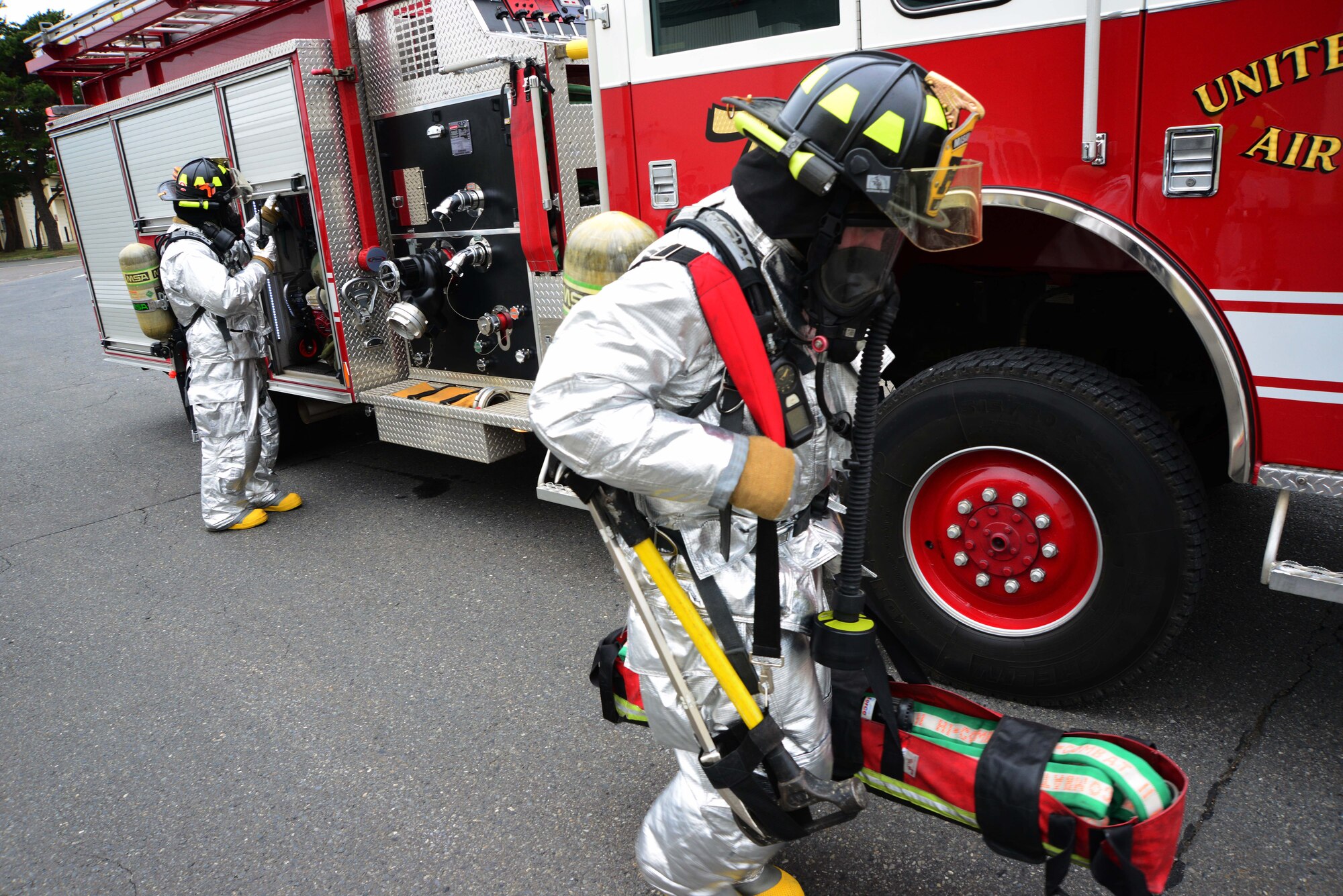 U.S. Air Force firefighters from the 35th Civil Engineer Squadron respond to a simulated attack during a week-long Operational Readiness Exercise at Misawa Air Base, Japan, May 5, 2014. Firefighters faced a high-stress scenario where they were required to extinguish a hangar fire while saving two injured Airmen. (U.S. Air Force photo/Senior Airman Derek VanHorn)
