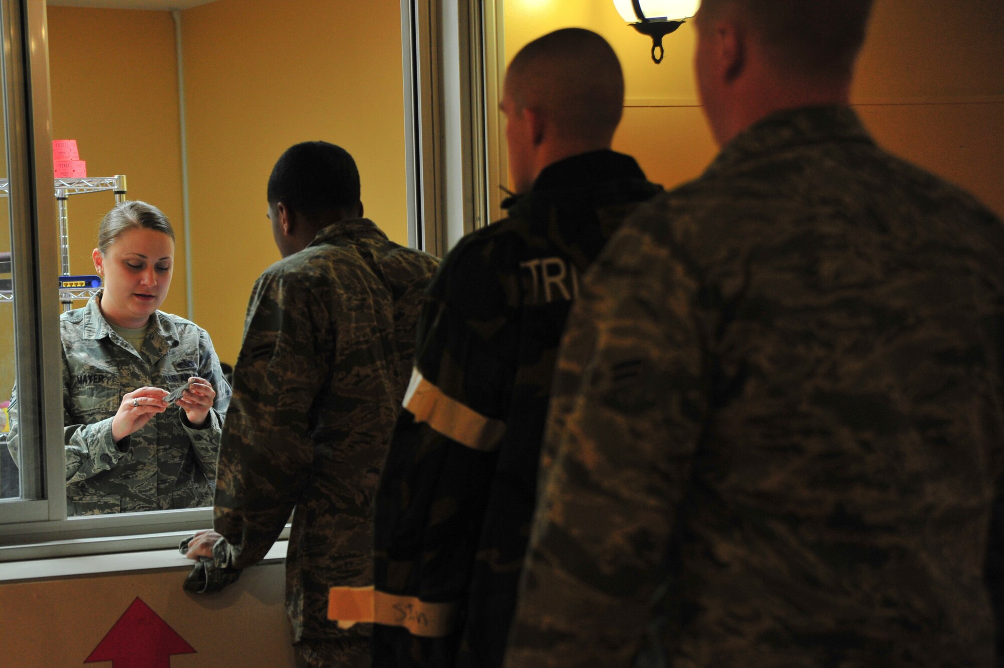 U.S. Air Force Staff Sgt. Lindsay Mayer, 35th Force Support Squadron NCO in Charge of installation personnel readiness, stamps an Airman's military identification card in the Transition Area during phase II of the Operational Readiness Exercise at Misawa Air Base, Japan, May 5, 2014.  As the TA NCOIC during the ORE, Mayer verifies Airmen receive daily updates about the current exercise situation. (U.S. Air Force photo/Senior Airman Jose L. Hernandez-Domitilo)