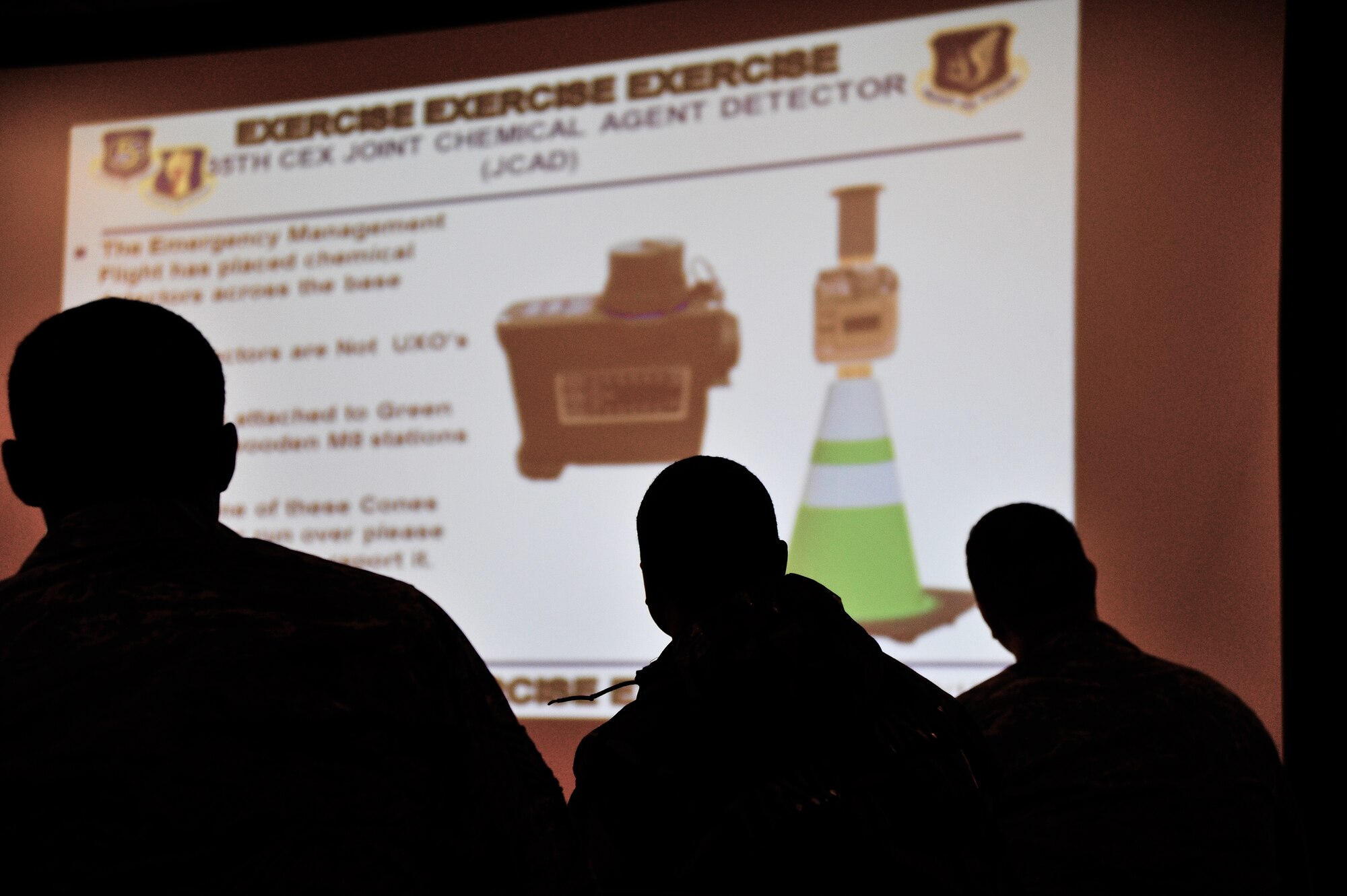 U.S. Air Force Airmen review daily updates of information regarding the Operational Readiness Exercise in the transition area prior to reporting to their duty location at Misawa Air Base, Japan, May 5, 2014. Although Airmen work at various locations around the base during an ORE, everyone starts their day at the TA. The TA is used to update Airmen on new mission oriented protective posture levels or any safety measures that have been implemented while they were off duty.  (U.S. Air Force photo/Senior Airman Jose L. Hernandez-Domitilo)