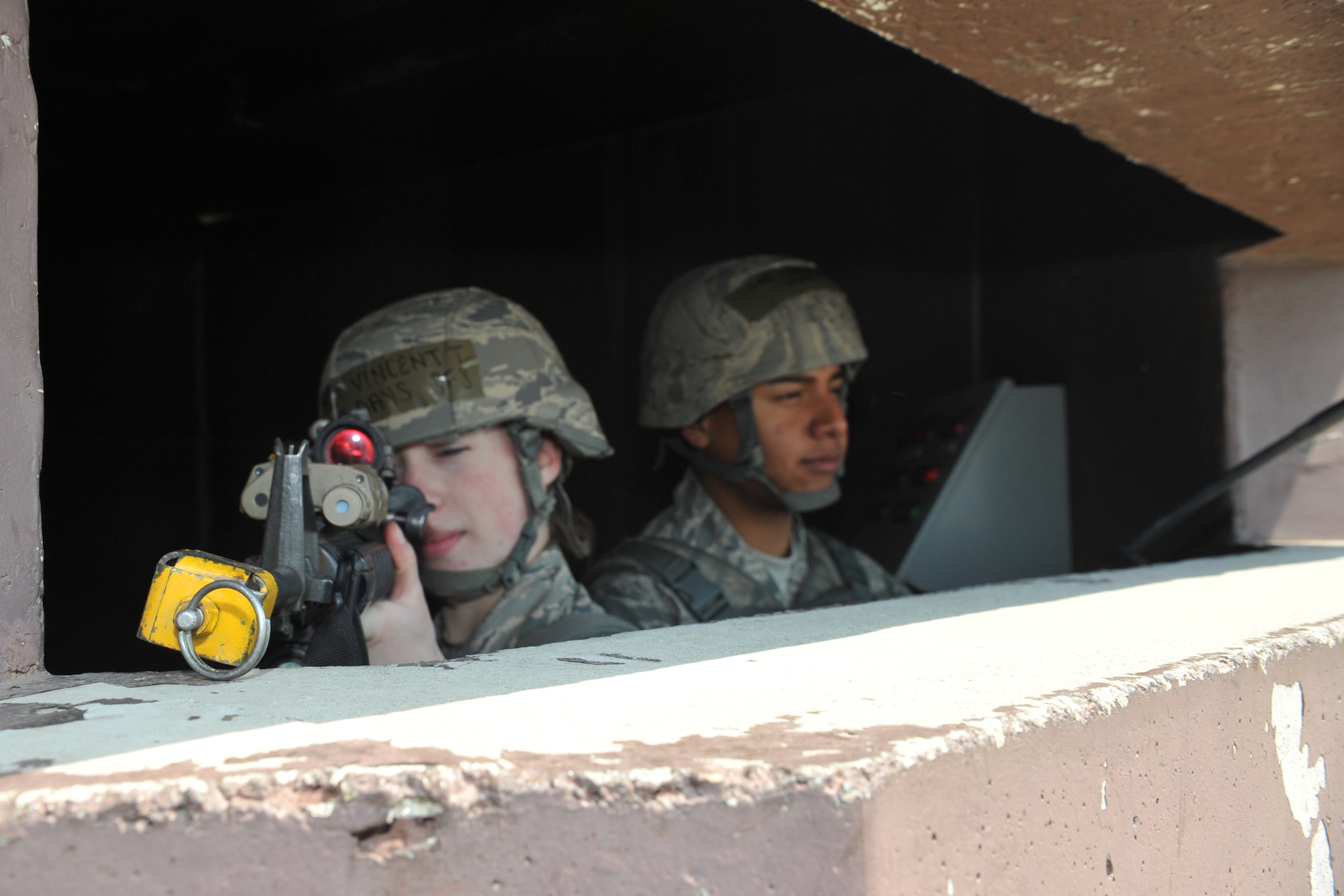 Airman 1st Class Tiffani Vincent and Senior Airman Pavel Aragon, 51st Security Forces Squadron entry controllers, man a defensive fighting position outside Bldg. 1097 during Operational Readiness Exercise Beverly Bulldog 14-02 at Osan Air Base, Republic of Korea, May 5, 2014. Defenders placed in DFPs must stay alert for any possible suspicious activity in the area. (U.S. Air Force photo/Airman 1st Class Ashley J. Thum)