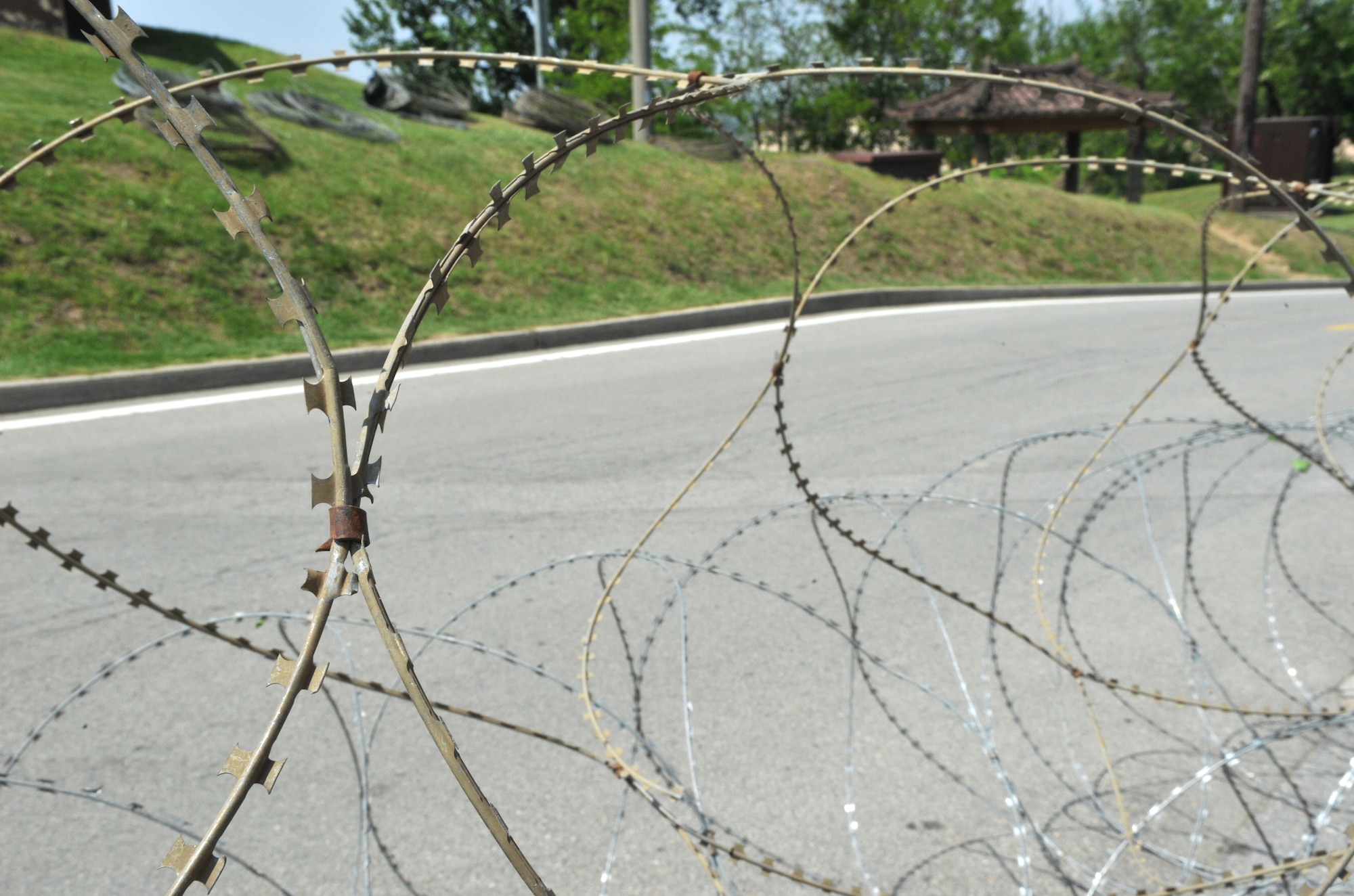 Concertina wire unfolds around Bldg. 1097 during Operational Readiness Exercise Beverly Bulldog 14-02 at Osan Air Base, Republic of Korea, May 5, 2014. The 51st Security Forces Squadron began implementing increased security measures around Bldg. 1097 to mitigate the chance of opposition forces infiltrating the area. (U.S. Air Force photo/Airman 1st Class Ashley J. Thum)