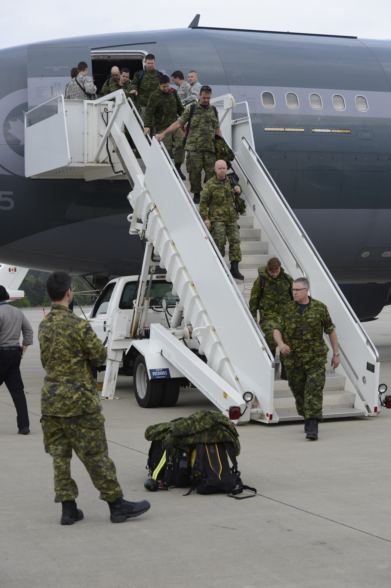 Royal Canadian Air Force service members disembark a transport aircraft on the flightline May 1, 2014, at Spangdahlem Air Base, Germany. The 52nd Fighter Wing and 726th Air Mobility Squadron here are forward-based, with ready forces trained and equipped to strengthen NATO partnerships by providing logistics and support to enable operations and enhance partner readiness. (U.S. Air Force photo by Staff Sgt. Christopher Ruano/Released)