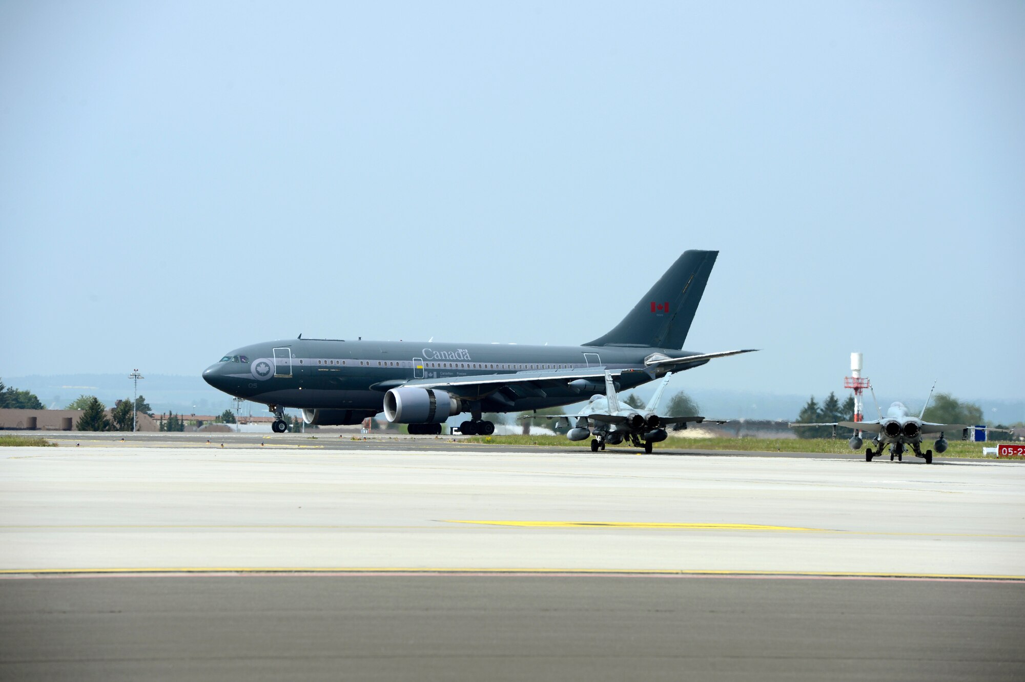 A Royal Canadian Air Force pilot lands a transport aircraft on the runway May 1, 2014, at Spangdahlem Air Base, Germany.  The RCAF aircraft will be based in Romania as part of NATO efforts to promote security and stability in Eastern and Central Europe. (U.S. Air Force photo by Staff Sgt. Christopher Ruano/Released)