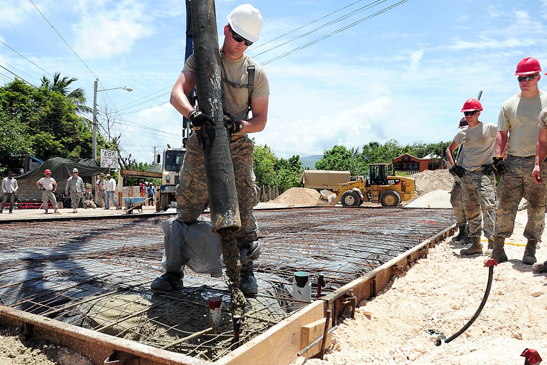 U.S. Army Sgt. Joshua Martz pours slurry for a medical clinic foundation during Beyond the Horizon 2014 in Barahona, Dominican Republic, April 24, 2014.