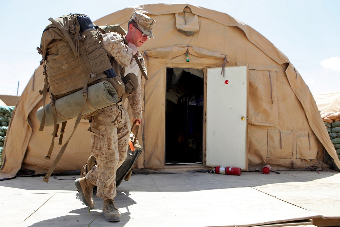 U.S. Marine Corps Cpl. Jeffery Mount moves his gear in preparation to leave Forward Operating Base Nolay in Afghanistan's Helmand province, for Camp Leatherneck, May 3, 2014. Mount is assigned to the 2nd Brigade, 215th Corps, Afghan National Army.