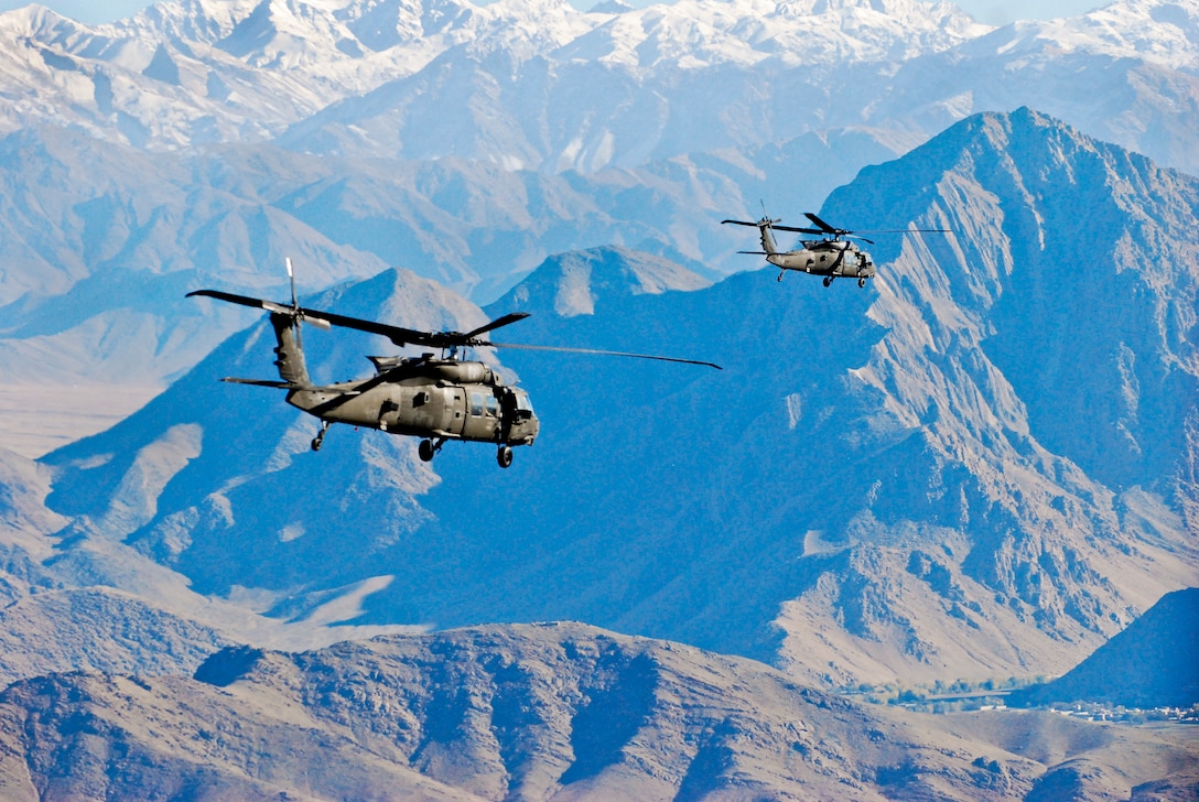 Two U.S. Army UH-60M Black Hawk helicopters fly over Logar province, Afghanistan, Nov. 11, 2013, during a mission to move personnel. The helicopters are assigned to 1st Battalion, 10th Combat Aviation Brigade.  
