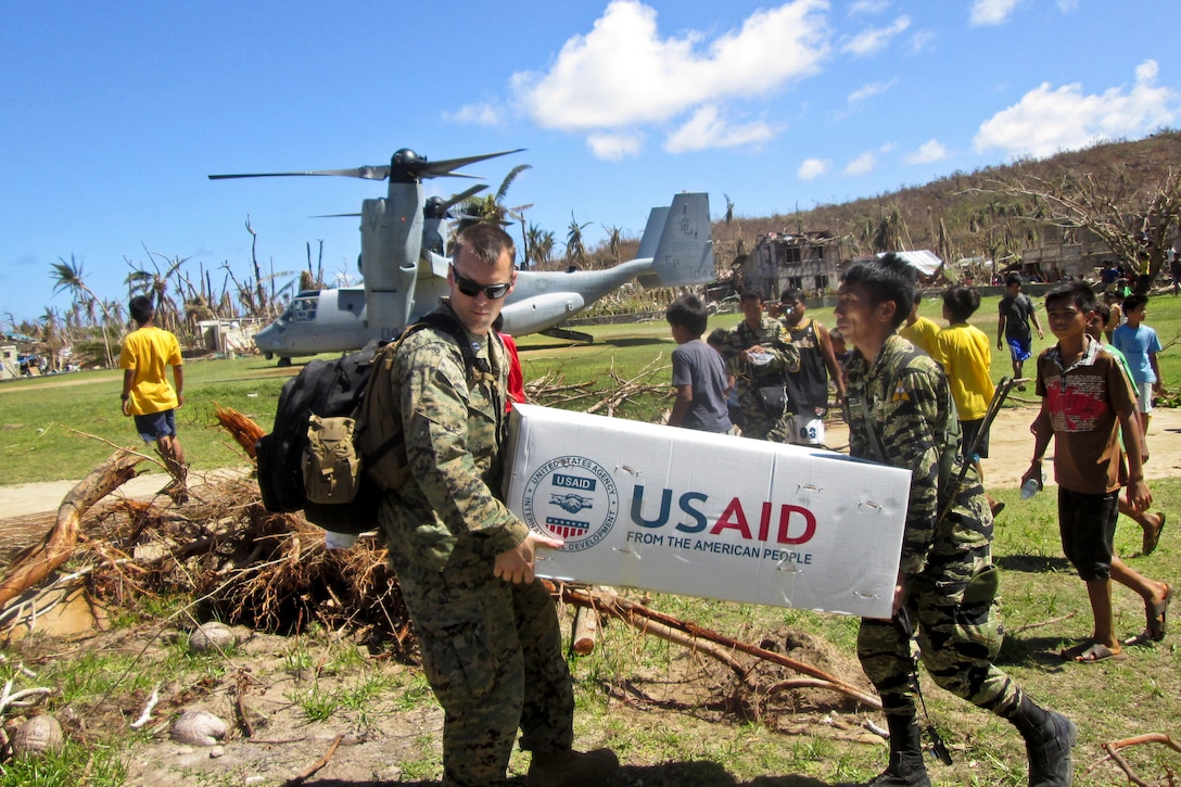 U.S. Marine Capt. Joseph White, left, and Philippine army Pfc. Vic D. Victorlano carry U.S. Agency for International Development relief supplies from an MV-22 Osprey in Pasay, Luzon, Philippines, Nov. 18, 2013. A bilateral assessment team landed to deliver relief and determine needs in remote areas in and near Leyte province to assess the needs of people isolated by Typhoon Haiyan. Barslow is the deputy logistics officer of the 31st Marine Expeditionary Unit.  