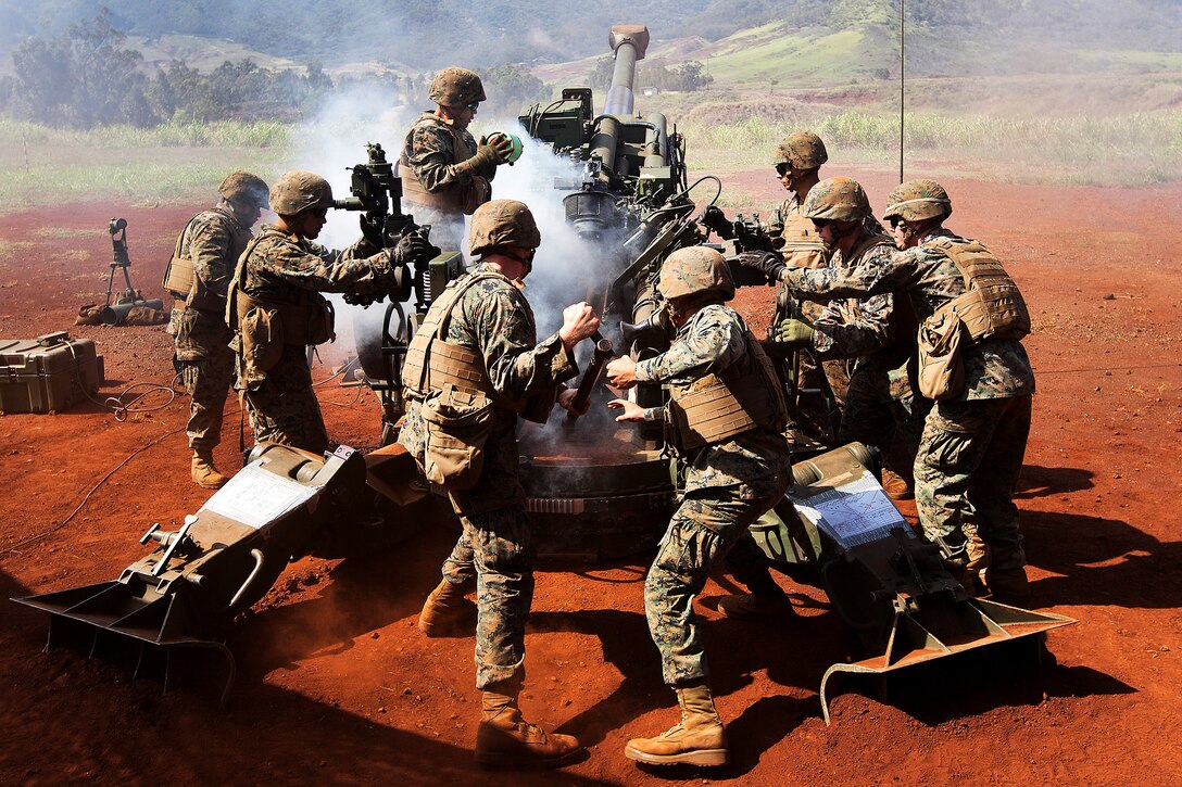Marines hastily reload an M777 howitzer with a 155-mm artillery shell as a part of a two-day dual-fire training exercise on Schofield Barracks, Hawaii, Nov. 13, 2013. The Marines also fired M327 towed-rifled mortar systems to eliminate the possibility of short-range threats on the battlefield and to expand the capabilities of the battery as a whole. The Marines are assigned to Bravo Battery, 1st Battalion, 12th Marine Regiment.  