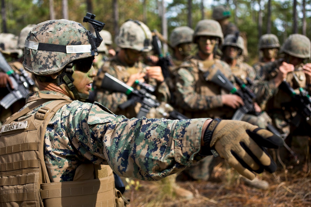 Marine Corps Sgt. David Rogers passes final instructions before an assault during the Infantry Integrated Field Training Exercise on Camp Geiger, N.C., Nov. 15, 2013. Rogers is assigned to Delta Company, Infantry Training Battalion, School of Infantry East. The unit is collecting data on the performance of female Marines when executing existing infantry tasks and training events.  