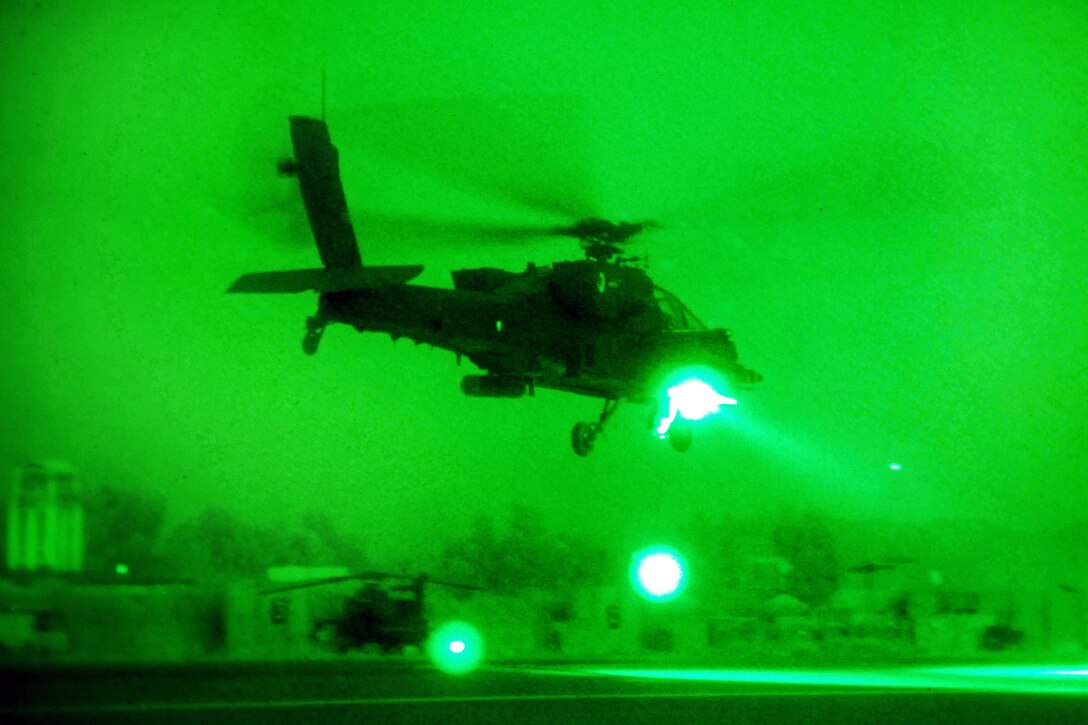 As seen through a night-vision device, an AH-64 Apache helicopter departs Forward Operating Base Fenty, Afghanistan, Oct. 17, 2013, to conduct a security and reconnaissance mission. The crew is assigned to the 1st Battalion Attack, 10th Combat Aviation Brigade. 
