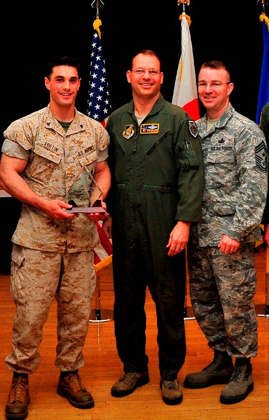 .S. Marine Cpl. Brock D. Fortin, left, poses for a photograph with U.S. Air Force Colonel Stephen C. Williams, center, and USAF Chief Master Sgt. Gary Sharp April 23 after earning the “Seikan War” Award for his outstanding performance and dedication throughout the Seikan War Exercise. Fortin conducted external coordination at the wing level with USAF units assigned to 35th Operations Group, 35th Fighter Wing, Misawa Air Base, Japan, alongside representatives with the Japan Air Self-Defense Force, and was instrumental in mission planning with large force exercise commanders and overall execution of the proposed plan. Fortin is a liaison officer with Marine Air Control Squadron 4, Marine Air Control Group 18, 1st Marine Aircraft Wing, III Marine Expeditionary Force. Williams is the commanding officer of the 35th Fighter Wing, and Sharp is the command chief master sergeant for the wing.