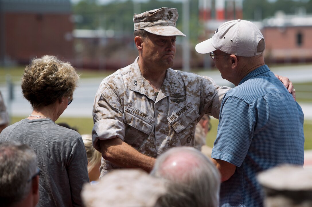 Major Gen. Mark A. Clark, commanding general of U.S. Marine Corps Forces Special Operations Command, embraces Russell Mote, the father of Sgt. Sky Mote, a recent Navy Cross recipient, during ‘Honor the Fallen,’ a one-of-a-kind event, April 25, at the MARSOC headquarters, to honor all Marines, sailors and civilian Marines lost at home and abroad since MARSOC’s inception. “As our journey together continues, today is about our promise to 45 special people in our lives, that they made a difference, they mattered, that they will be remembered and will always hold a coveted place in our hearts,” said Clark.