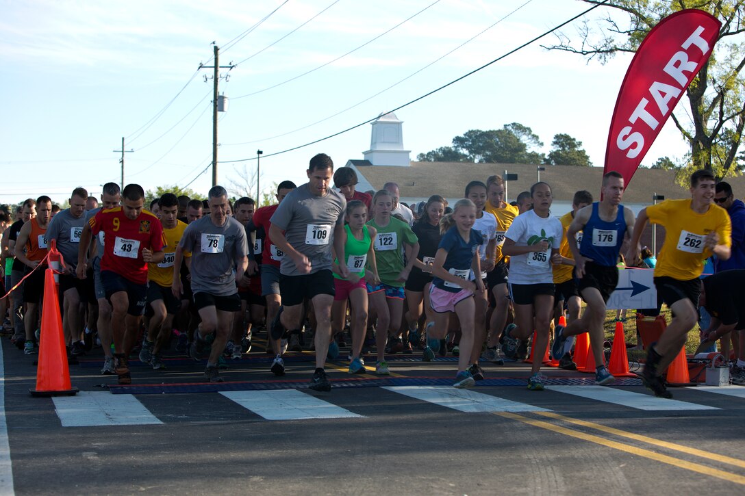More than 1,400 competitors darted from the start line as they began the muddy and murky 5-mile MARSOC Mud, Sweat and tears run at Stone Bay aboard Marine Corps Base Camp Lejeune, N.C., April 26.  The MARSOC mud run provides MARSOC the opportunity to connect with the local community and build camaraderie amongst the Marines at MCB Camp Lejeune. This year’s mud run held a special significance as the families of some of MARSOC’s fallen Marines and sailors ran in the race, following ‘Honor the Fallen,’ a one-of-a-kind event, the day prior that honored all Marines, sailors and civilian Marines lost at home and abroad since MARSOC’s inception. (Official U.S. Marine Corps photo by Sgt. Scott Achtemeier)