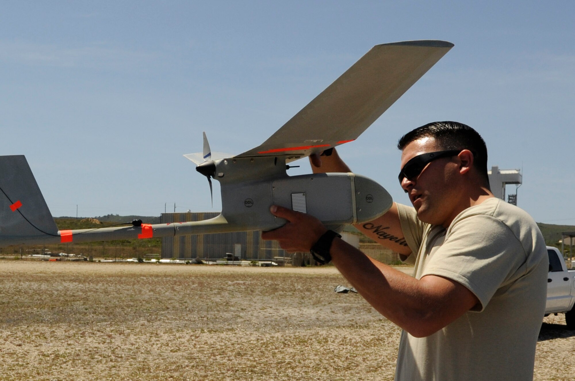 Staff Sgt. William Huster inspects a type of unmanned aerial vehicle, known as Raven-B/DDL, April 30, 2014, at Vandenberg Air Force Base, Calif. With an aim to enhance comprehensive base safety and security, the 30th Security Forces Squadron is bolstering its Small Unmanned Aircraft System program. Huster is the 30th SFS NCO in-charge of force protection and intelligence. (U.S. Air Force photo/Senior Airman Shane Phipps) 