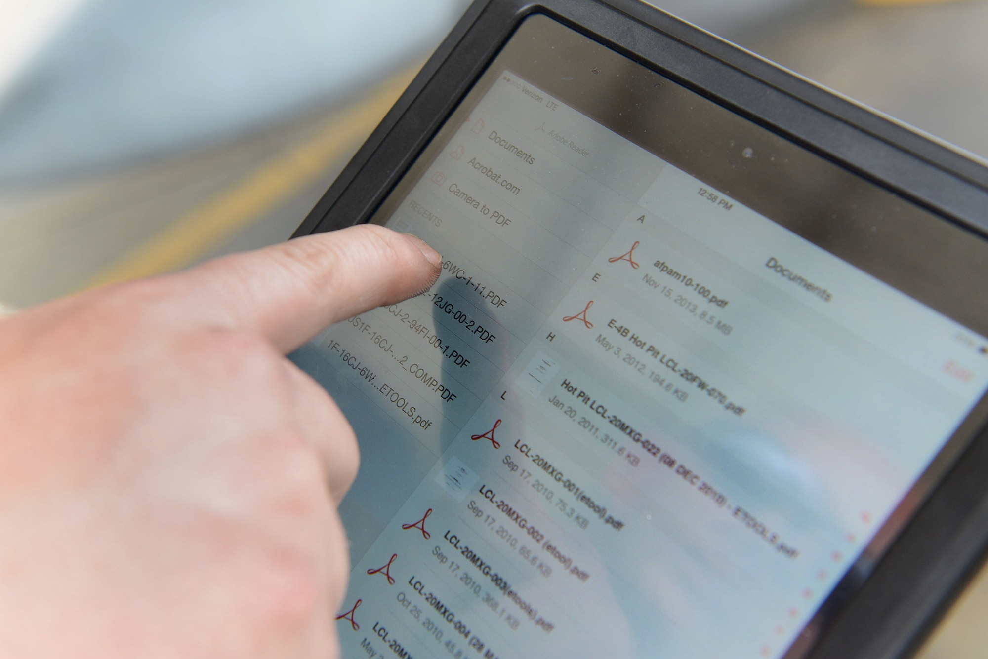 An Airman selects a file on the iPad version of a technical order manual before conducting maintenance on an F-16CJ Fighting Falcon at Shaw Air Force Base, S.C., April 29, 2014. The 20th Aircraft Maintenance Squadron, 55th Aircraft Maintenance Unit tested ease of navigation of the new platform to  compare the older version of a technical order manual.. (U.S. Air Force photo by Airman 1st Class Jensen Stidham)
