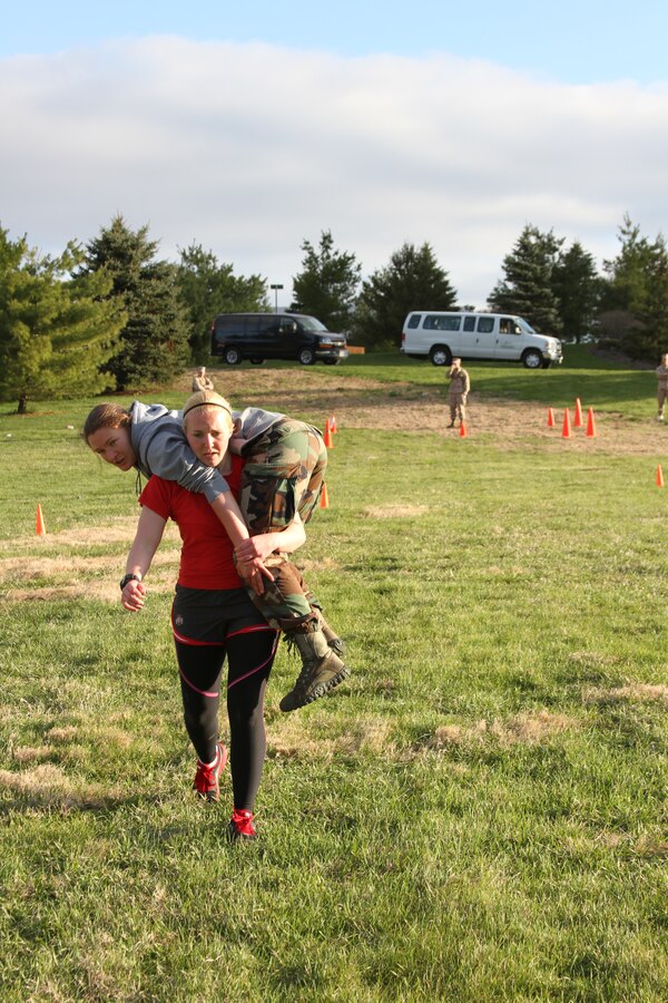 Olivia Waugh, a future U.S. Marine Corps officer candidate, carries Rebekah Mazany during a Combat Fitness Test held during an Officer Candidates School preparatory weekend at Camp Woodward, Pa. April 25-27, 2014. The purpose of the weekend was to give the candidates a realistic view of how physically, mentally and emotionally demanding OCS will be. (U.S. Marine Corps photo by Sgt. Tyler Hlavac/Released)
