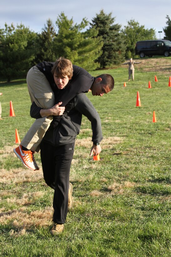 Greg Haylett, a future U.S. Marine Corps officer candidate, carries Sam Cosen during a Combat Fitness Test held during an Officer Candidates School preparatory weekend at Camp Woodward, Pa. April 25-27, 2014. The purpose of the weekend was to give the candidates a realistic view of how physically, mentally and emotionally demanding OCS will be. (U.S. Marine Corps photo by Sgt. Tyler Hlavac/Released)