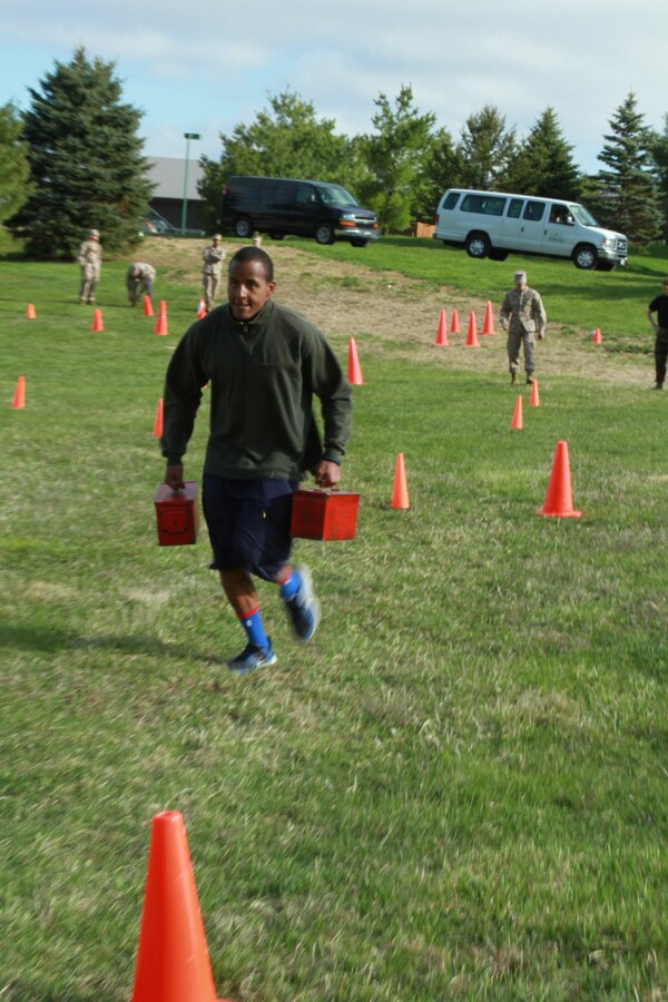 Malik Birks, a future U.S. Marine Corps officer candidate, carries a pair of ammo cans during a Combat Fitness Test held during an Officer Candidates School preparatory weekend at Camp Woodward, Pa. April 25-27, 2014. The purpose of the weekend was to give the candidates a realistic view of how physically, mentally and emotionally demanding OCS will be. (U.S. Marine Corps photo by Sgt. Tyler Hlavac/Released)