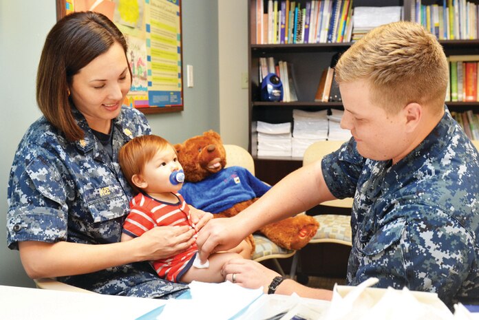 JACKSONVILLE, Fla. – Seaman Christian Snyder, assigned to Naval Hospital Jacksonville, Fla., Maternal Infant Unit, sterilizes the skin of a child prior to administering an annual influenza vaccination. It is recommended that everyone, age six months and older, get an annual flu vaccination. 