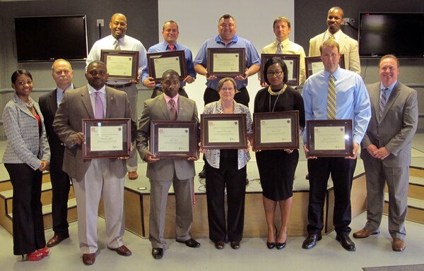 During a graduation ceremony at the Center May 6, Center Contracting interns Michael Ashworth, Christina Bott-Lamb, Jonathan Brown, Jeffery Byrd, Joshua Clark, Thomas Delaney, Timothy Griffin, Raven Nall, Patluke Ragucci and Joaquin Tucker were officially welcomed into the fold of U.S. Army Engineering and Support Center, Huntsville.  