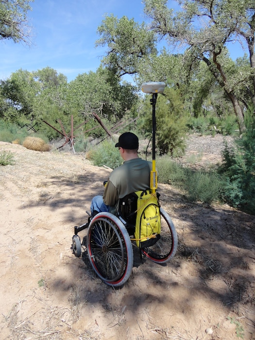 BERNALILLO COUNTY, N.M., -- Bryan Estvanko surveys using equipment set up by fellow District employee Ronnie Casaus.  Taken Sept. 23, 2012 on the Rio Grande Levee in the Bosque by Gary Edwards.