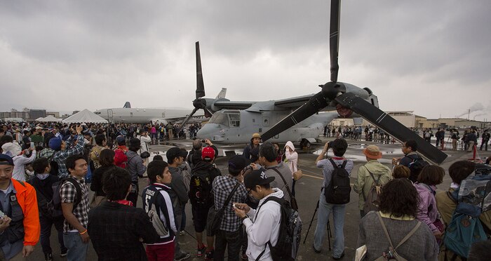 Patrons gather around an MV-22B Osprey aircraft as they observe and take photos of the aircraft during Friendship Day aboard Marine Corps Air Station Iwakuni, Japan, May 5, 2014. The Osprey is with Marine Medium Tiltrotor Squadron 265 from 1st Marine Aircraft Wing, Okinawa, Japan. Friendship Day is an event that allows Japanese citizens a chance to see military vehicles and aircraft, meet American service members and get a taste of American culture. 