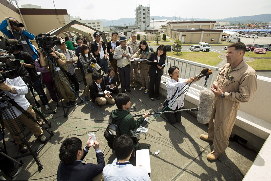 Japanese media members interview Col. Robert Boucher, commanding officer of Marine Corps Air Station Iwakuni, Japan, during Friendship Day May 5, 2014. More than 50,000 people came aboard MCAS Iwakuni to see military vehicles and aircraft, meet American service members and get a taste of American culture.