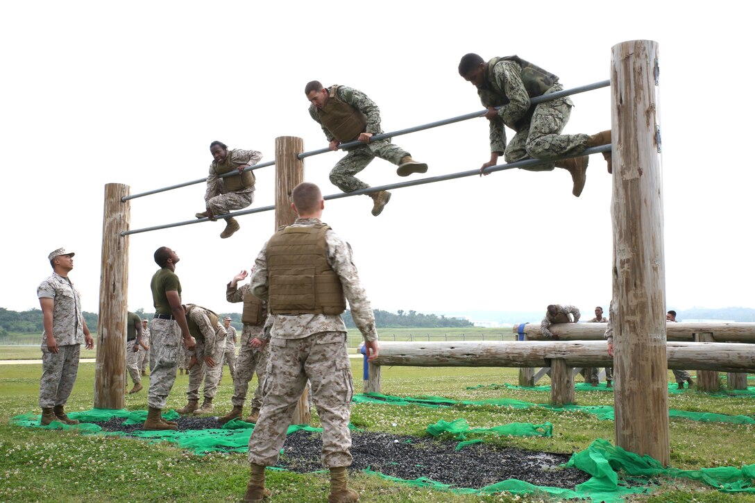 Marines and sailors race through an obstacle course May 1 during a battalion super squad competition at Marine Corps Air Station Futenma. Super squad builds camaraderie between Marines and sailors who would not normally work together. The competitors are with Headquarters and Service Battalion, Marine Corps Base Camp Smedley D. Butler, Marine Corps Installations Pacific. 
