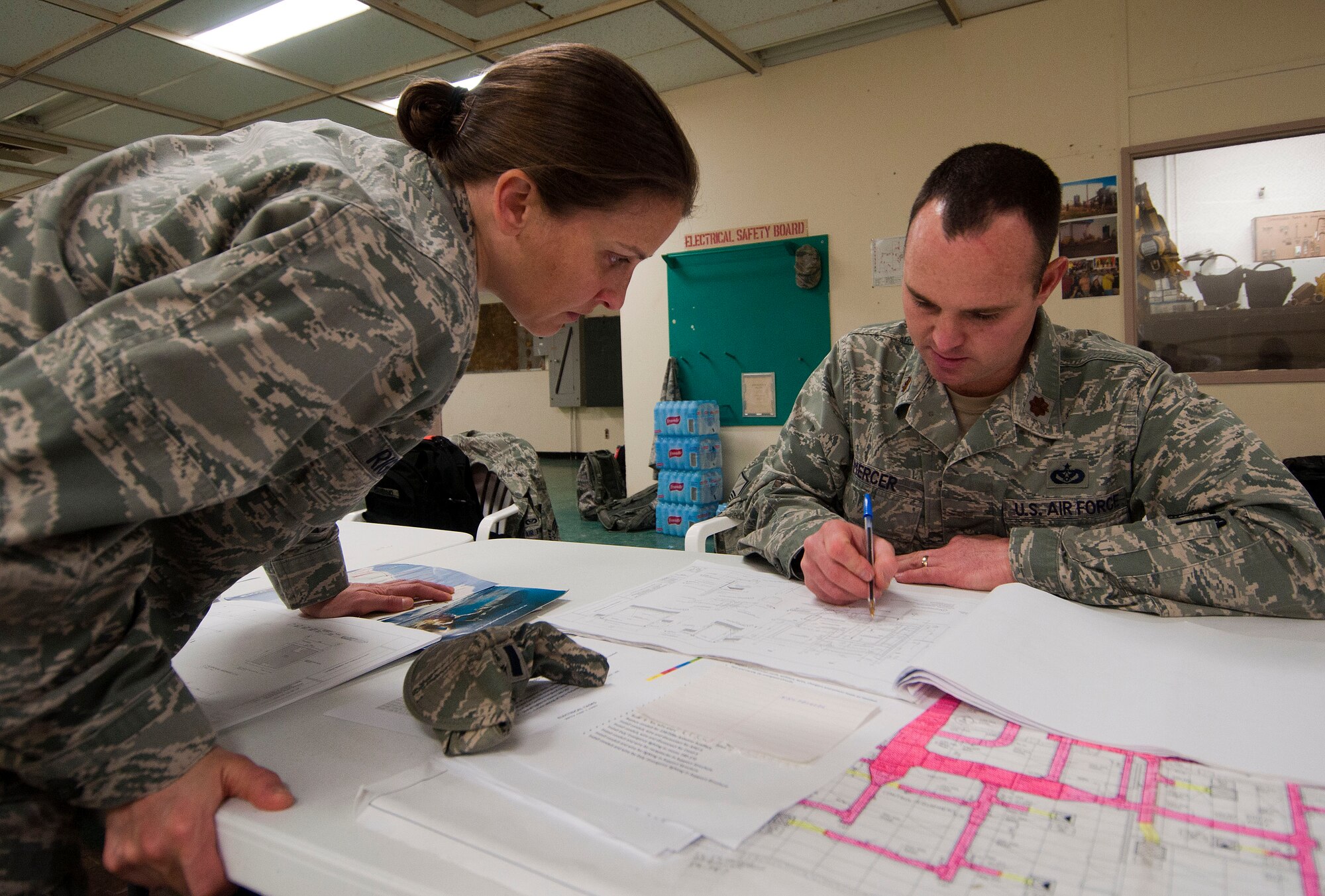 H.E. HOLT NAVAL COMMUNICATION STATION, Australia – Maj. Kim Riggs, construction flight chief for the Alaska Air National Guard’s 176th Civil Engineer Squadron, and Maj. Chris Mercer, the squadron’s infrastructures flight chief, study blueprints for the facility here May 6, 2014. The two were among thirty-four Alaska Air Guard members, most from the 176th CES, who deployed for two weeks to this tiny outpost at the far western tip of Australia to help build a space radar facility to be jointly operated by Australia and the United States. National Guard photo by Capt. John Callahan.