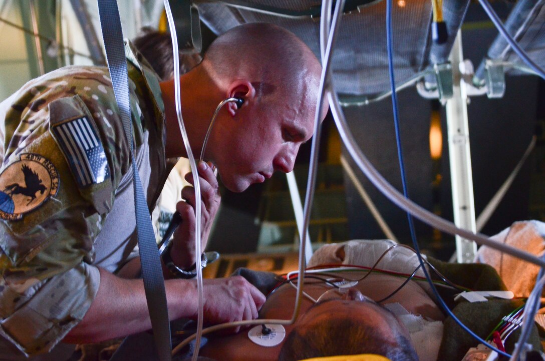 U.S. Air Force Capt. Russell Gray, 48th Rescue Squadron flight surgeon, checks the breathing of a sailor rescued 1,100 nautical miles off the Pacific Coast of Mexico, May 5, 2014. The sailor was hoisted from a ship 540 nautical miles off the Pacific Coast of Mexico, then transported by a 79th RQS HC-130J Combat King II to Naval Air Station North Island, Calif. (U.S. Air Force photo by Staff Sgt. Adam Grant/Released)