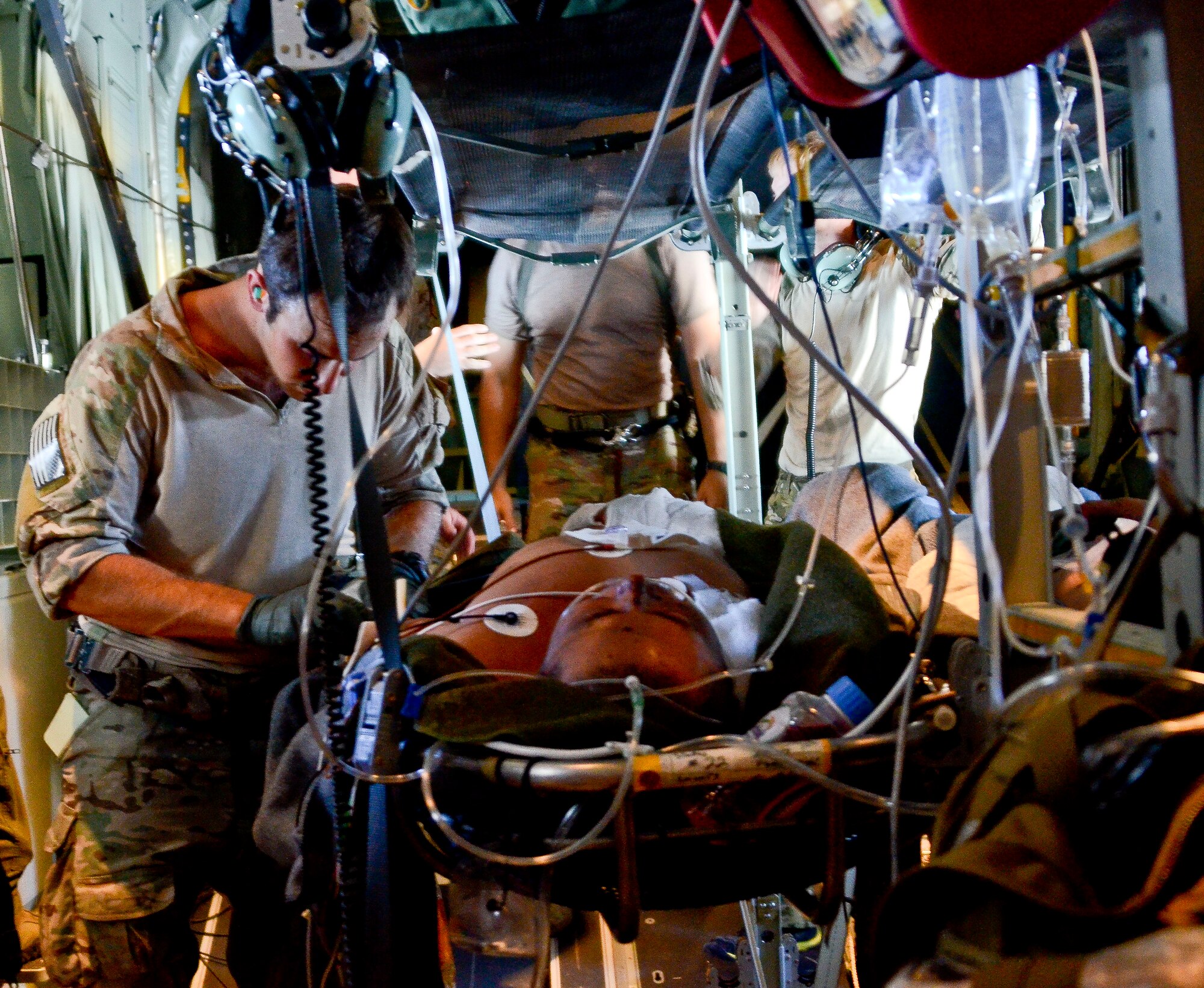 U.S. Air Force Staff Sgt. Casey Lutz, 48th Rescue Squadron Pararescueman, inserts an IV into the arm of a sailor rescued 1,100 nautical miles off the Pacific Coast of Mexico, May 5, 2014. The sailor was hoisted from a ship 540 nautical miles off the Pacific Coast of Mexico, then transported by a 79th RQS HC-130J Combat King II to Naval Air Station North Island, Calif. (U.S. Air Force photo by Staff Sgt. Adam Grant/Released)