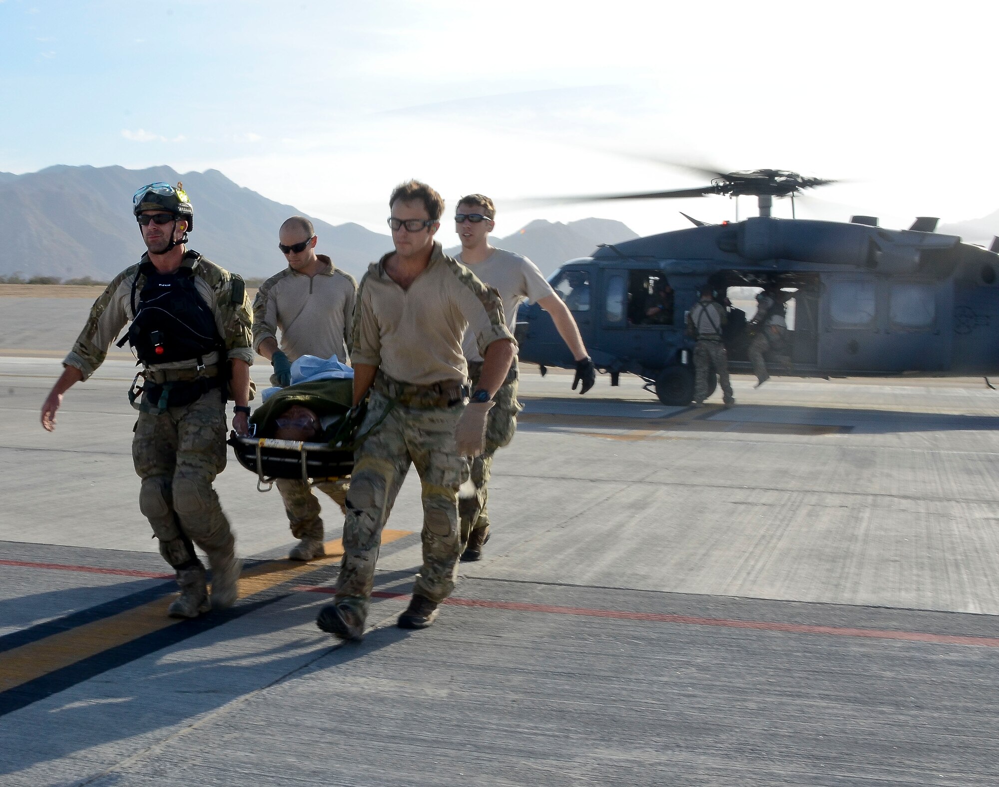U.S. Air Force Pararescuemen from the 48th Rescue Squadron off-load patients from a 55th RQS HH-60G Pavehawk at Cabo San Lucas International Airport, Mexico, May 5, 2014. The Pavehawks extracted two injured sailors and six Guardian Angels from a ship 540 nautical miles off the Pacific Coast of Mexico, then transported by a 79th RQS HC-130J Combat King II to Naval Air Station North Island, Calif. (U.S. Air Force photo by Staff Sgt. Adam Grant/Released)