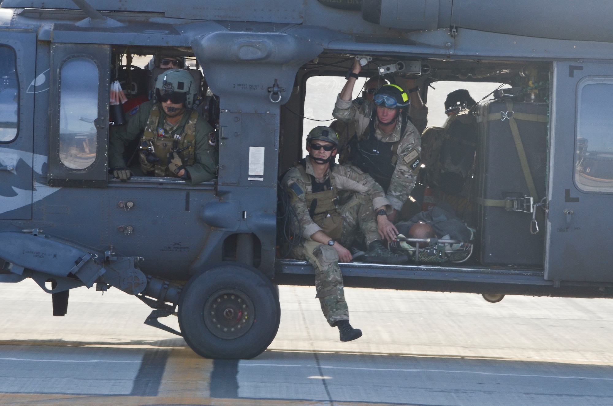 U.S. Air Force Pararescuemen from the 48th Rescue Squadron prepare to off-load patients from a 55th RQS HH-60G Pavehawk at Cabo San Lucas International Airport, Mexico, May 5, 2014. The Pavehawks extracted two injured sailors and six Guardian Angels from a ship 540 nautical miles off the Pacific Coast of Mexico, then transported by a 79th RQS HC-130J Combat King II to Naval Air Station North Island, Calif. (U.S. Air Force photo by Staff Sgt. Adam Grant/Released)