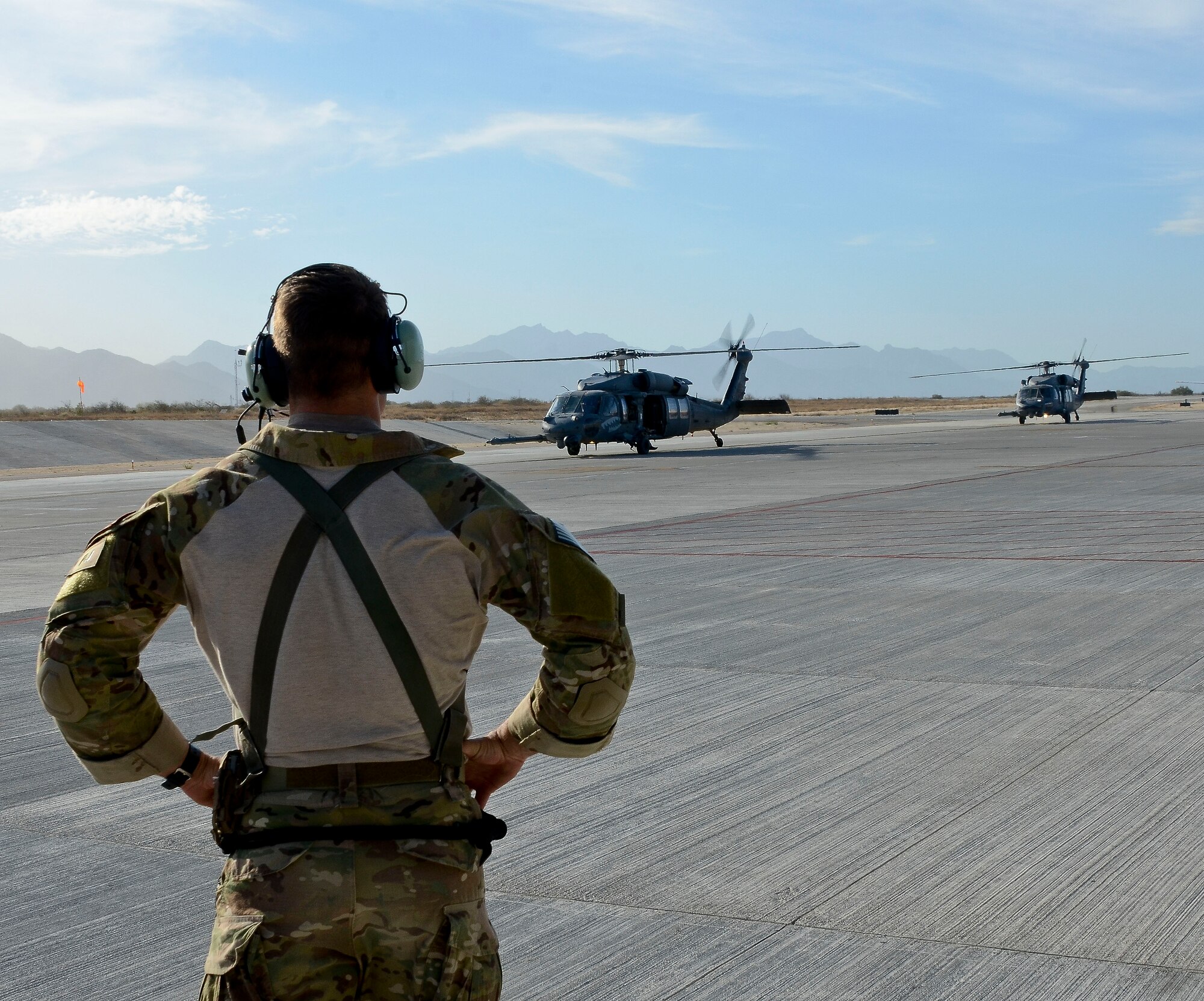 U.S. Air Force Master Sgt. Chris Young, 48th Rescue Squadron Pararescueman in control of patient transportation operations, prepares to receive injured patients from two 55th RQS HH-60G Pavehawks after they land at Cabo San Lucas International Airport, Mexico, May 5, 2014. The Pavehawks extracted two injured sailors and six Guardian Angels from a ship 540 nautical miles off the Pacific Coast of Mexico, then transported by a 79th RQS HC-130J Combat King II to Naval Air Station North Island, Calif. (U.S. Air Force photo by Staff Sgt. Adam Grant/Released
