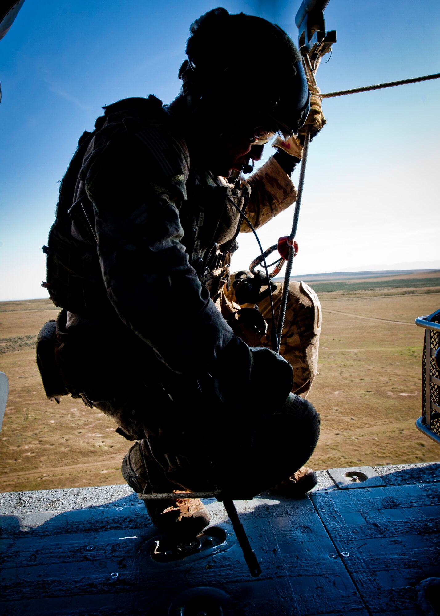 A U.S. Air Force pararescueman prepares to rappel out of an HH-60 Pave Hawk during the U.S. Air Force Weapons School terminal employment phase, April 29, 2014, at Orchard Combat Training Range, Idaho.  The pararescuemen supported the U.S. Air Force Weapons School, 34th Weapons Squadron in training scenarios during the TE phase.  (U.S. Air Force photo by Senior Airman Jason Couillard)