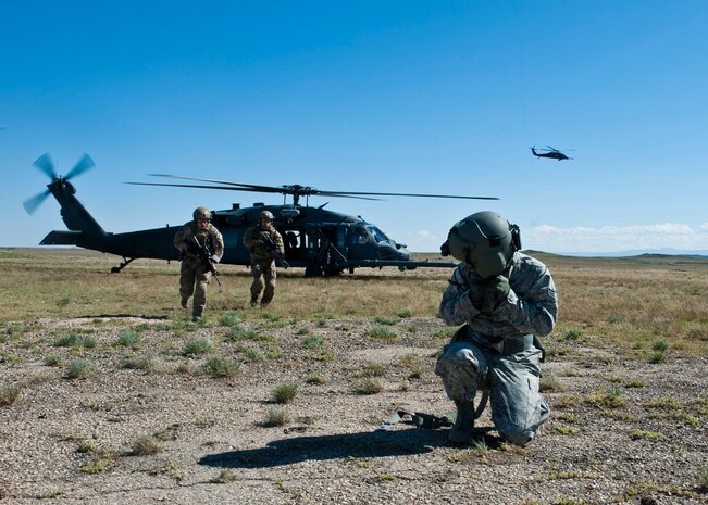 U.S. Air Force pararescuemen assigned to the 347th Rescue Group, Moody Air Force Base, Ga. rescue a simulated survivor during the U.S. Air Force Weapons School, 34th Weapons Squadron terminal employment phase portion of pilot training April 28, 2014, at Orchard Combat Training Center, Idaho.  The U.S. Air Force Weapons School encompasses 18 squadrons, teaching 24 weapons instructor courses and 30 combat specialties at eight locations. (U.S. Air Force photo by Senior Airman Jason Couillard)