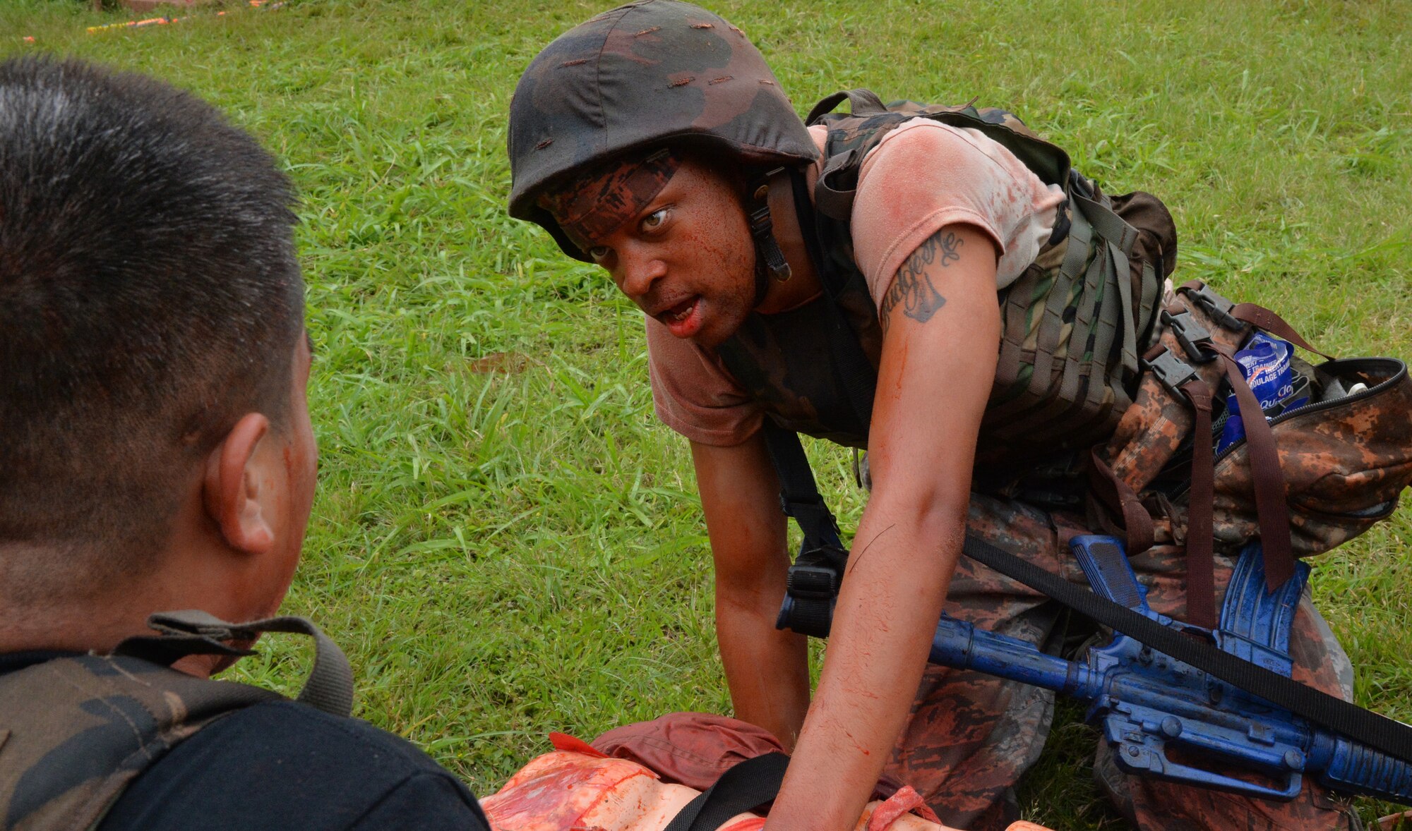 Staff Sgt. Tyrone Shannon, 15th Medical Group, provides medical care to a simulated injured patient during a Tactical Combat Casualty Care course at Schofield Barracks, Hawaii, May 2, 2014. Shannon was one-of-two Air Force personnel in the Navy course. During the 3-day course, Navy and Air Force medics were instructed on how to provide casualty care in a combat environment. (U.S. Air Force photo/Staff Sgt. Alexander Martinez)