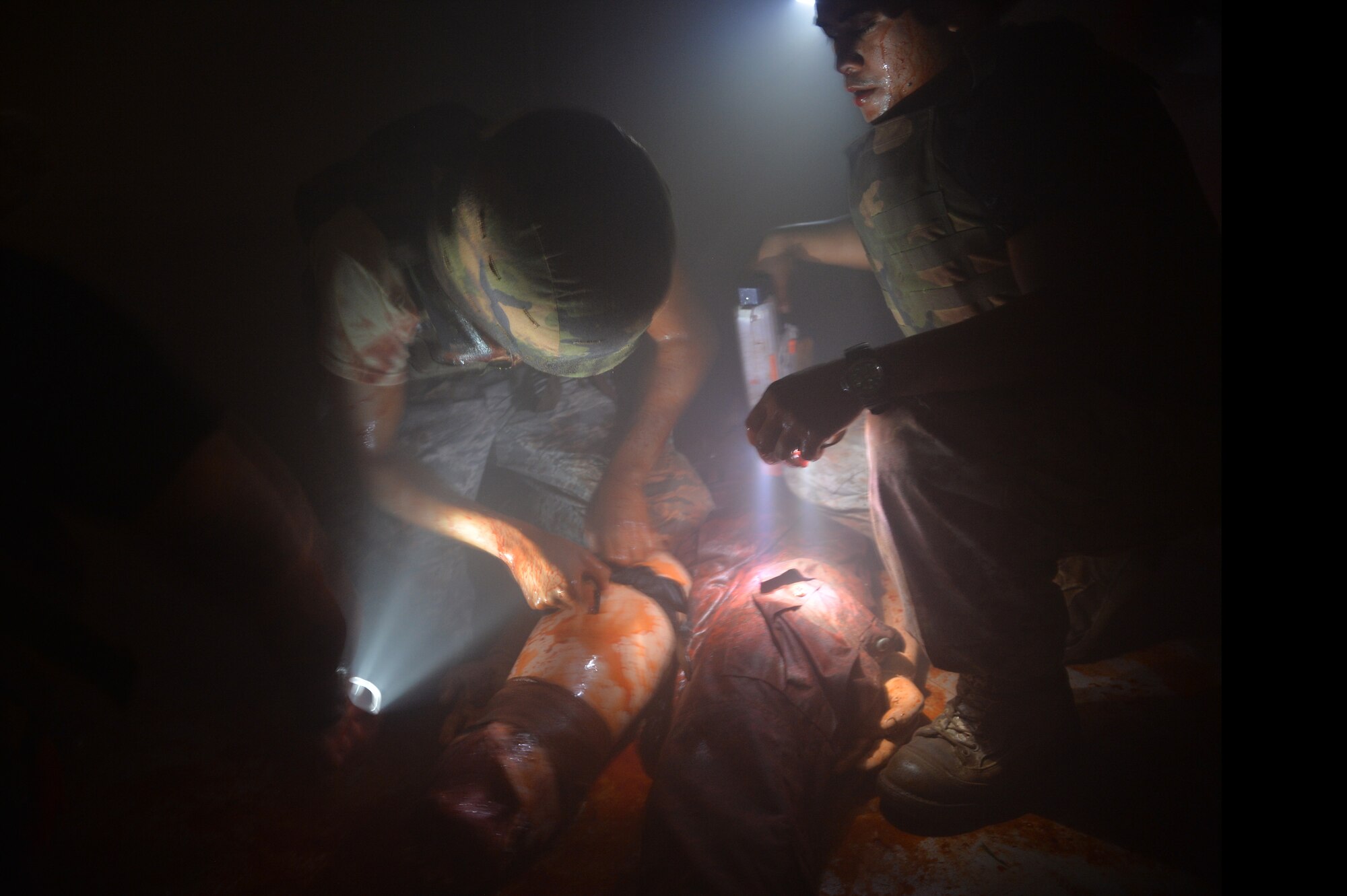 Staff Sgt. Tyrone Shannon (left), 15th Medical Group, provides medical care to a simulated injured patient during a Tactical Combat Casualty Care course at Schofield Barracks, Hawaii, May 2, 2014. Shannon was one-of-two Air Force personnel in the Navy course. During the 3-day course, Navy and Air Force medics were instructed on how to provide casualty care in a combat environment. (U.S. Air Force photo/Staff Sgt. Alexander Martinez)